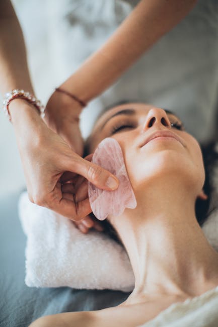 woman demonstrating gentle eye massage technique with fingers around eye area in relaxing spa environment